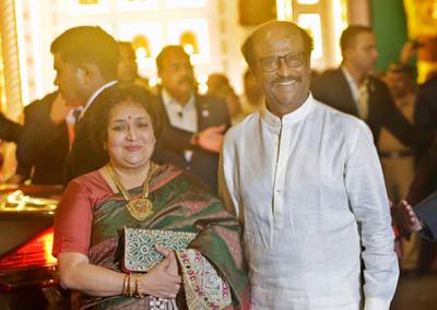 Indian superstar Rajinikanth and his wife Latha Rajinikanth arrive. AP Photo