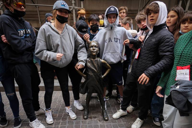 People stand by the Fearless Girl Statue, by artist Kristen Visbal, outside of the New York Stock Exchange in New York, New York. Reuters