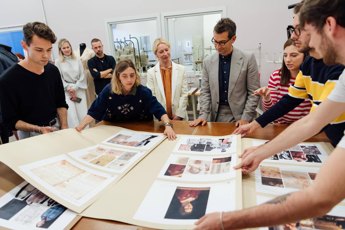 Marchetti discusses mood boards with the project's Italian students in Milan. Courtesy YNAP