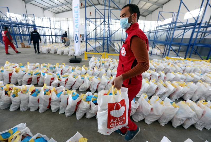 epa08334961 A Tunisian Red Crescent member prepares food packages to be delivered to the elderly and needy families during the ongoing emergency measures over the ongoing pandemic of the novel coronavirus disease (COVID-19), in Ben Arous, Tunisia, 31 March 2020. Tunisian Minister of Health Mekki, announced on the day the official launch of a new mobile application called 'STOP Corona'. The free app would asses users' health by asking a series of questions. Pending the results of the answers, individuals will be asked to reach dedicated departments concerned in performing analysis to diagnose whether the subjects may be infected with the COVID-19 disease, media reported.  EPA/MOHAMED MESSARA