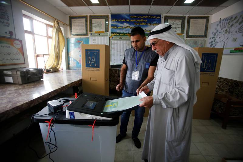 An Iraqi man casts his vote at a polling station during the parliamentary election in the Sadr city district of Baghdad. Thaier al-Sudani / Reuters