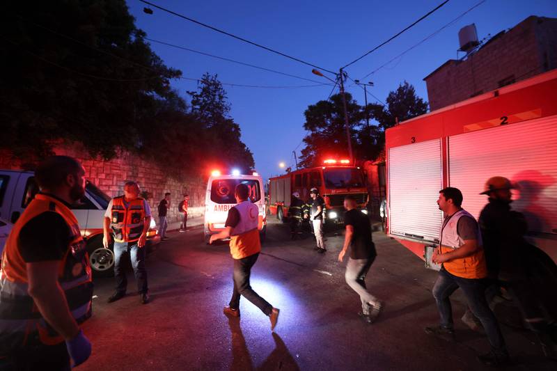Palestinian Red Crescent rescuers rush to move the wounded to safety after the gun battle. AFP