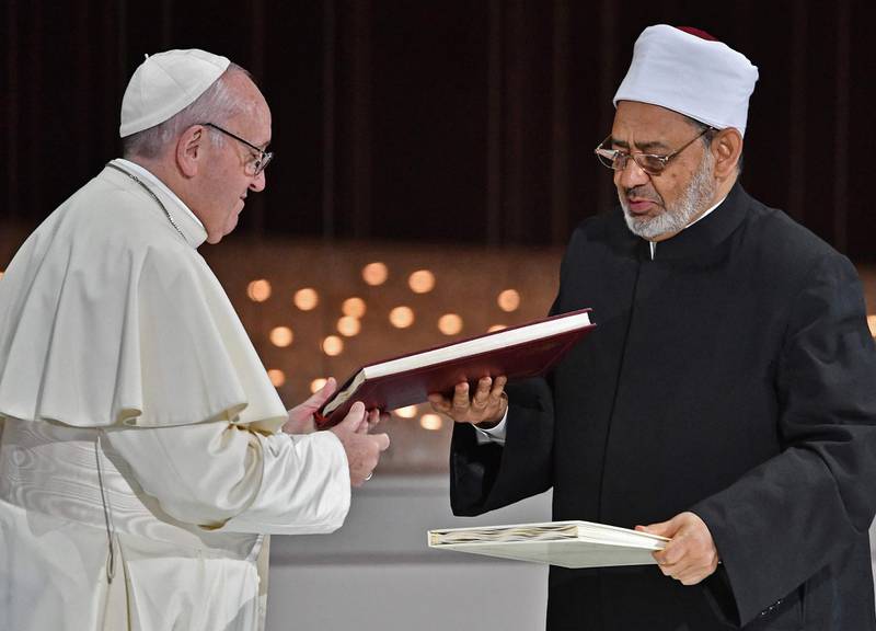 The religious leaders exchange documents. AFP