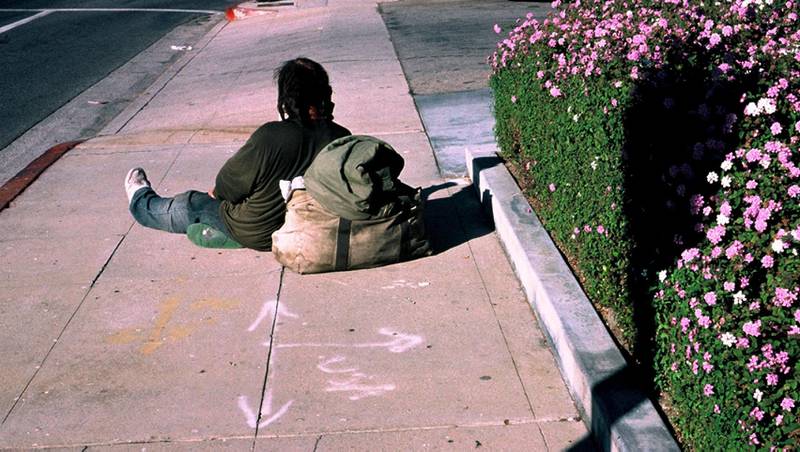 A homeless man in Sherman Oaks, a Los Angeles suburb, takes a rest on the sidewalk. Photo: Gilbert Mercier