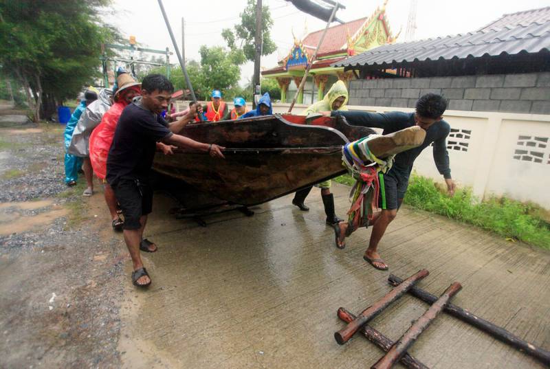 Local fishermen move a boat ashore in preparation for the approaching Tropical Storm Pabuk, Friday in Pak Phanang, in the southern province of Nakhon Si Thammarat, southern Thailand.  AP Photo