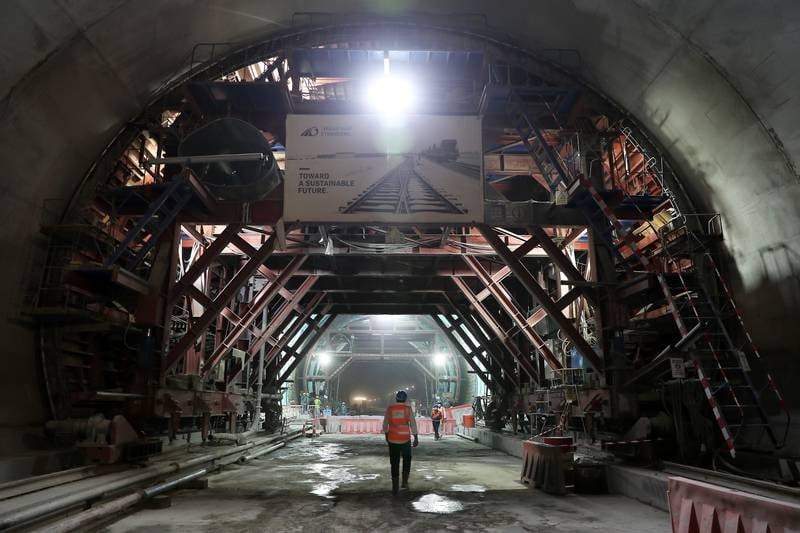 Workers inside the Etihad Rail tunnel in Fujairah. At 1.8km, T1 is the largest of nine tunnels carved through the Hajar Mountains.