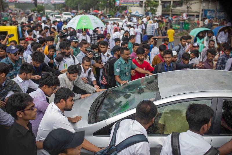 Protesting students block a car to check the vehicle's registration and the driver's license during a rally demanding safe roads on the seventh consecutive day of protests, in Dhaka city, Bangladesh.  EPA / MONIRUL ALAM
