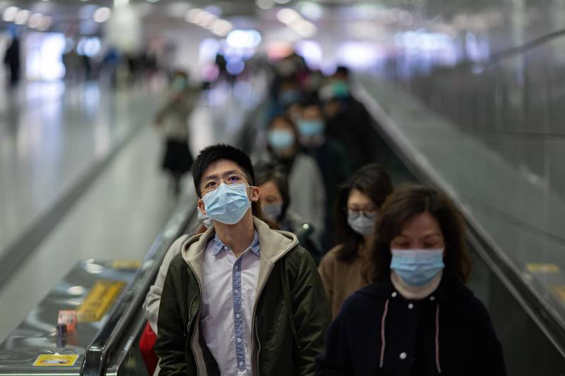 Commuters wear face masks in the MTR in Hong Kong.  EPA