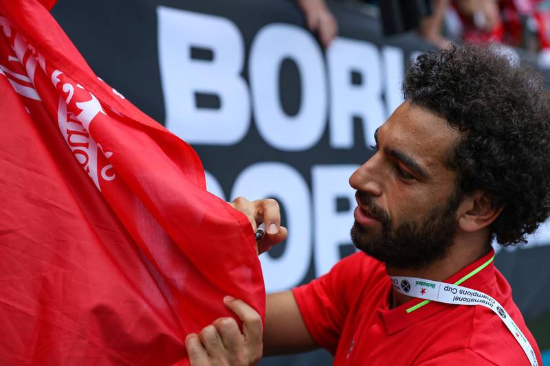 Liverpool's Mohamed Salah signs autographs following the match. Reuters