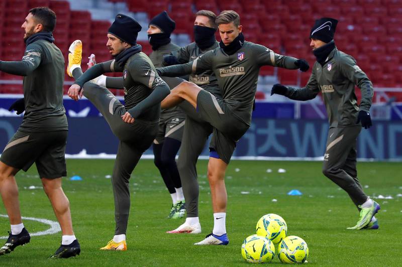 Atletico Madrid's players, including Marcos Llorente, centre, during a training session at Wanda Metropolitano Stadium. Atletico were forced to hold Monday's training session at their stadium due to severe snow in the Spanish capital. EPA