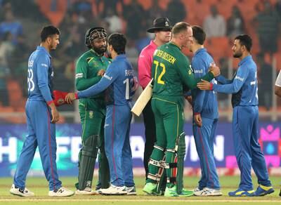 South Africa's Andile Phehlukwayo and Rassie van der Dussen shake hands with Afghanistan players. Reuters