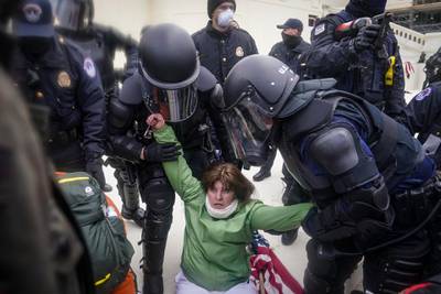 A woman is helped up by police during a rally Wednesday, Jan. 6, 2021, at the Capitol in Washington. AP Photo