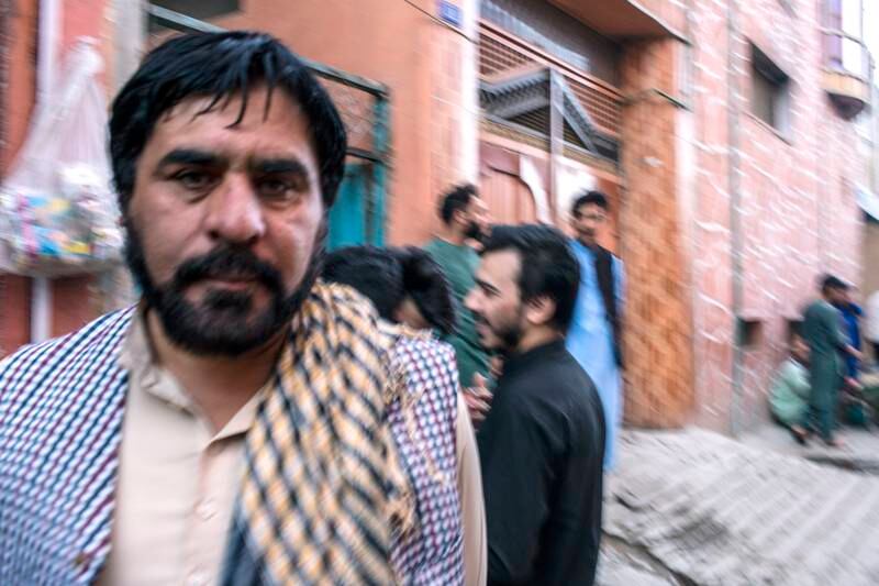 Rasool Khaliqi, a drummer, and other musicians stand on a corner of Kharabat Street.