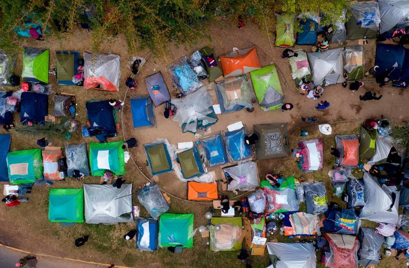 Ariel view showing stranded Bolivian citizens at a makeshift camp in front of Bolivia's consulate in Santiago waiting for a solution to their situation as the borders were closed due to the coronavirus COVID-19 pandemic.  AFP
