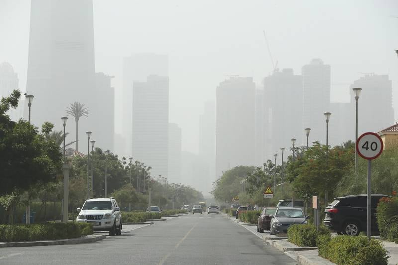 Jumeirah Lake Towers loom out of the haze in Dubai. Pawan Singh / The National