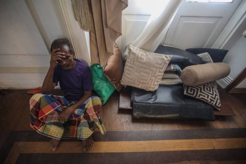 A man takes a rest inside the prime minister's official residence in Colombo. EPA
