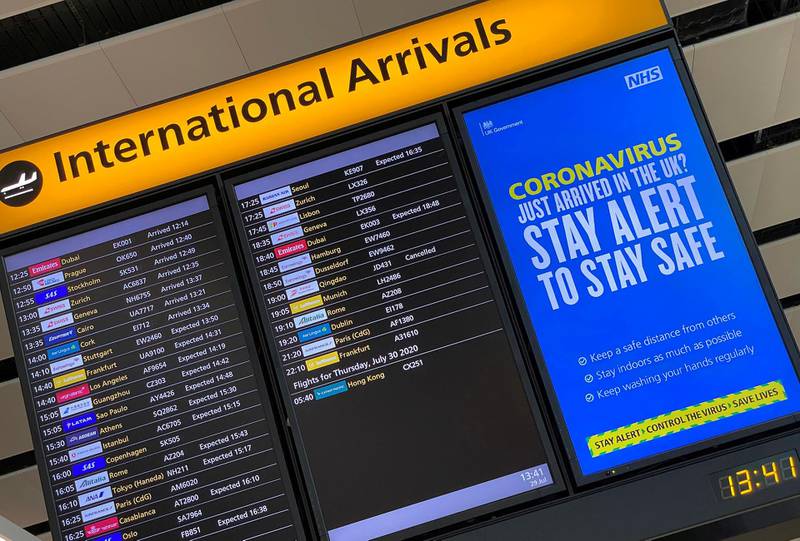 FILE PHOTO: A public health campaign message is displayed on an arrivals information board at Heathrow Airport, following the outbreak of the coronavirus disease (COVID-19), London, Britain, July 29, 2020. REUTERS/Toby Melville/File Photo