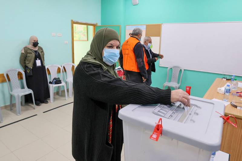 A woman casts her vote during municipal elections, in the village of Baitain, east of the occupied West Bank city of Ramallah. The previous municipal vote took place in 2017. AFP