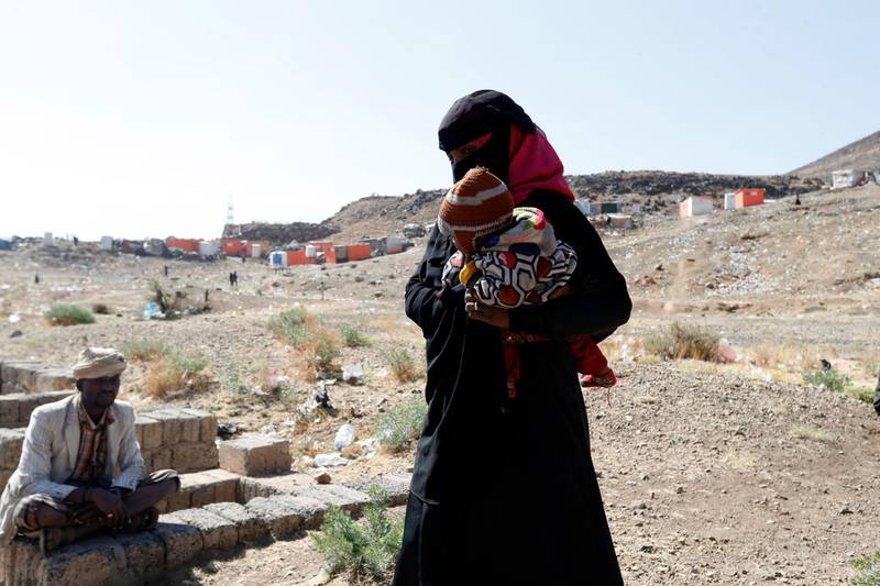 A displaced Yemeni woman holds her baby at a camp for Internally Displaced Persons (IDPs) on the outskirts of Sana'a, Yemen. EPA
