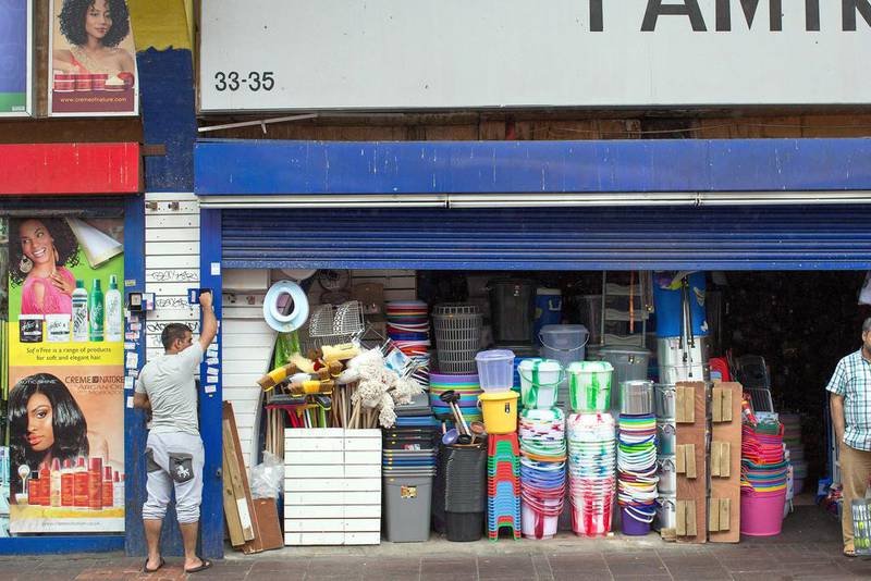 A man closes the shutter on his shop under Brixton Arches. Once regeneration work is done around 50 small businesses and up to 150 jobs are likely to be lost. Dan Kitwood / Getty