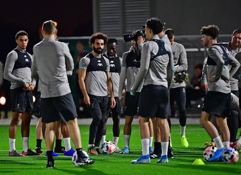 Liverpool's Egyptian midfielder Mohamed Salah (C) takes part in a team training session at Qatar University. AFP