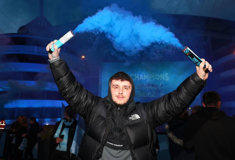 Fans celebrate at the Etihad Stadium after Manchester City were crowned Premier League champions. PA