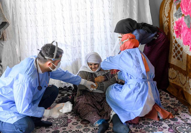 Nurse Yildiz Ayten gives a Covid-19 vaccination to Berfo Arsakay, a 101-year-old woman in the village of Guneyyamac in eastern Turkey. AFP
