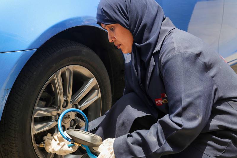 At the garage, female recruits check oil and change tyres alongside their male counterparts.  