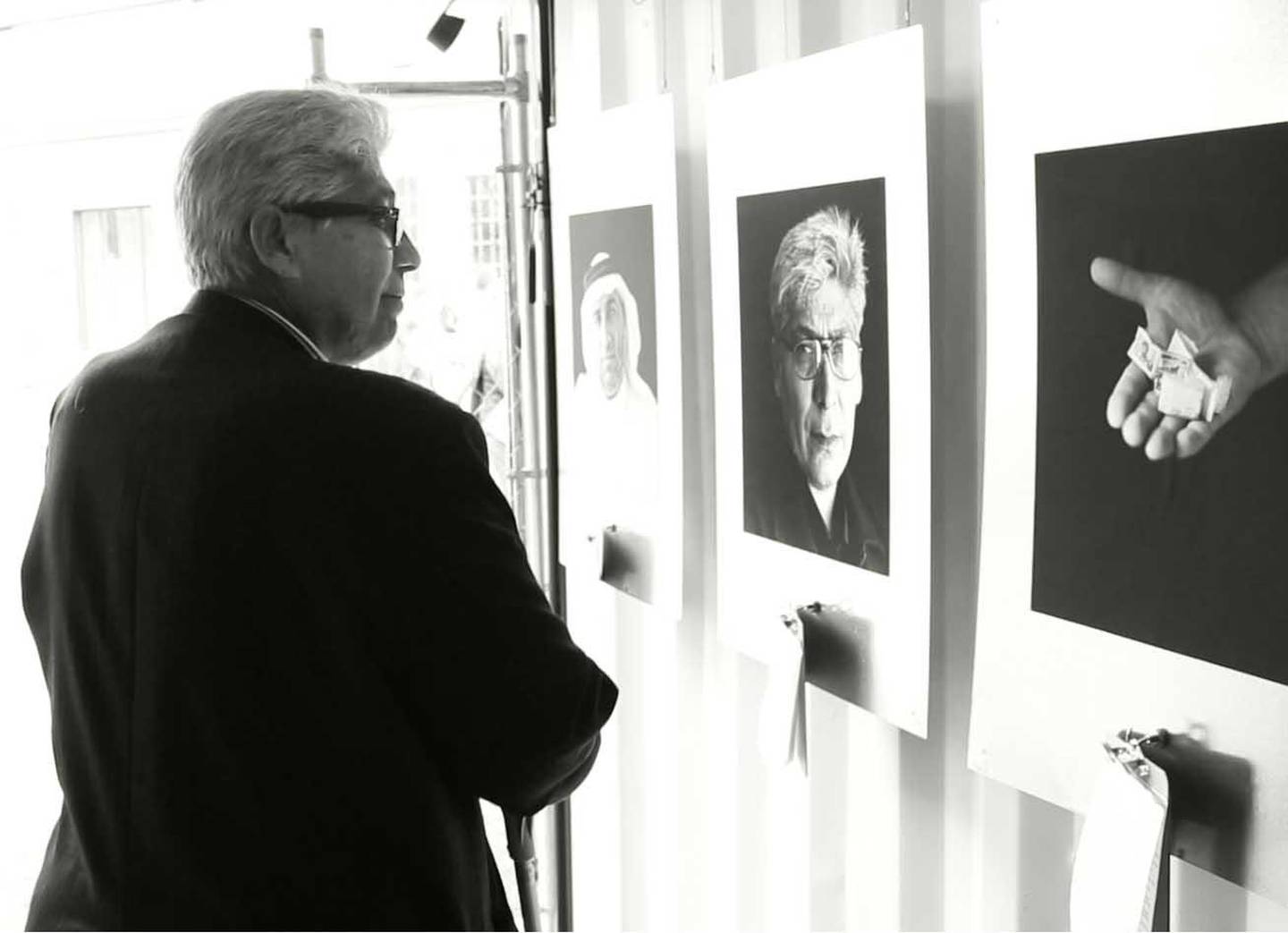 Haj Ali (Ali Alqaisi) viewing his portrait in Hamburg Germany at the Hamburg Triennale, 2105. Photo by Chris Bartlett