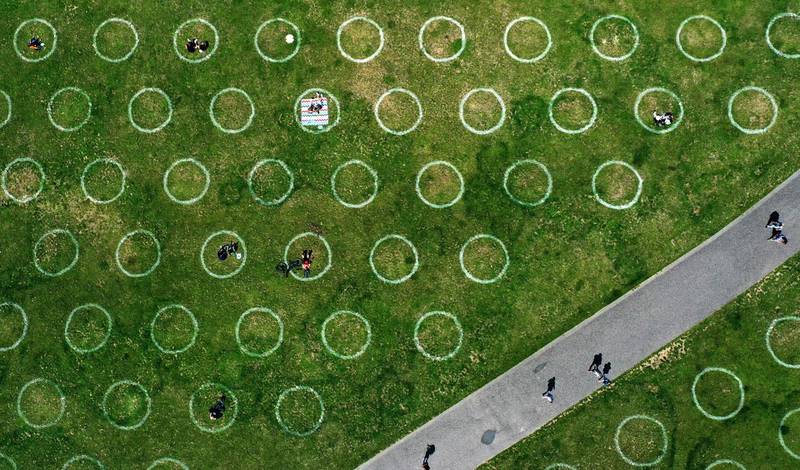 An aerial view shows a field with painted circles for social distancing at the Rhine promenade in Duesseldorf, western Germany.  AFP