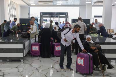 Muslim pilgrims arriving from north-western Syrian areas pass baggage checks at the Bab Al-Hawa border crossing with Turkey. AFP