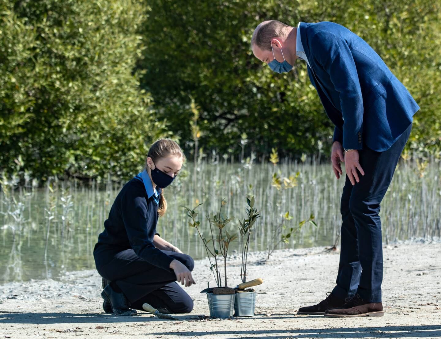 Prince William plants mangrove seedlings with children at Jubail Mangrove Park in Abu Dhabi.Victor Besa / The National