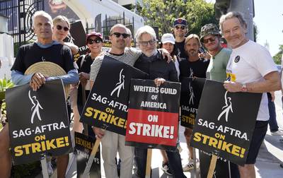 Cast and writers from "Breaking Bad" and "Better Call Saul" pose on a picket line outside Sony Pictures studios on Tuesday, Aug.  29, 2023, in Culver City, Calif.  The film and television industries remain paralyzed by Hollywood's dual actors and screenwriters strikes.  Pictured from left are Patrick Fabian, Rhea Seehorn, Norma Maldonado, Aaron Paul, Peter Gould, Betsy Brandt, Matt Jones, Charles Baker, Jesse Plemons and Bryan Cranston (AP Photo / Chris Pizzello)