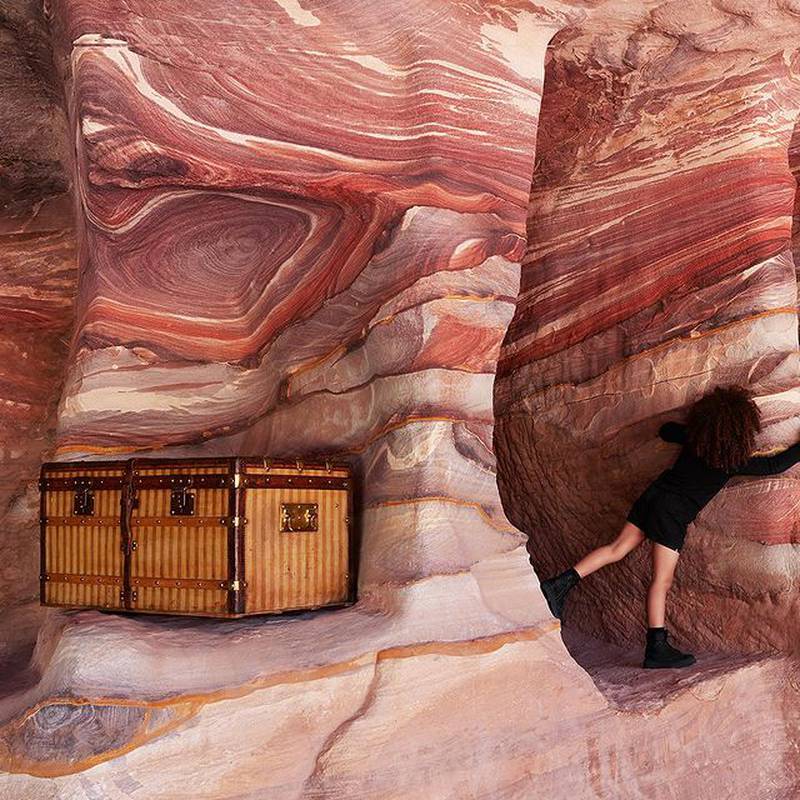 Children play on the pink rocks of Petra in the new campaign.
