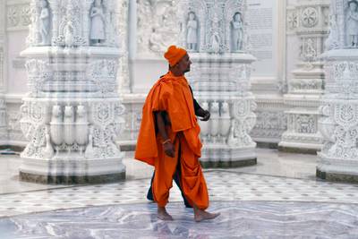 A monk walks inside the temple before the opening. AFP