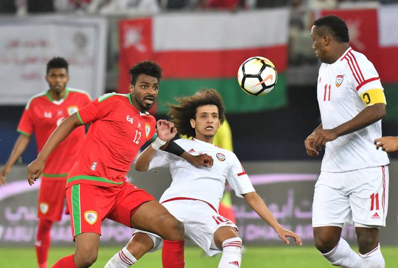 The UAE's Omar Abdulrahman, centre, vies for the ball against Oman's Ahmed Mubarak. Giuseppe Cacace / AFP