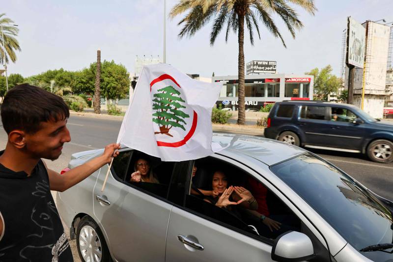 Lebanese Forces supporters show their backing for the party as a man waves an LF flag in Byblos, north of Beirut. AFP
