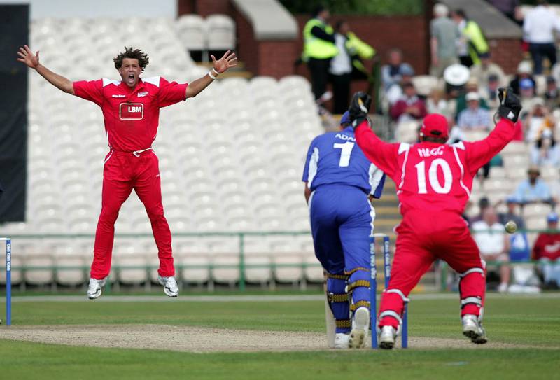 Andrew Symonds celebrates taking the wicket of Sussex's Chris Adams while playing for Lancashire. PA