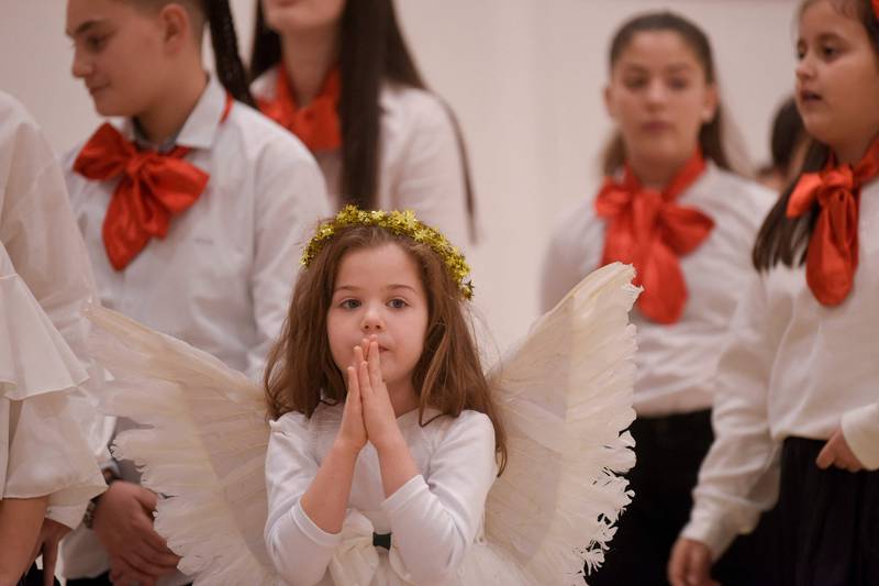 A child dressed as an angel attends Mass at the Mother Teresa Cathedral in Pristina, Kosovo. AFP