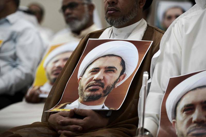 Members of Wefaq carry placards bearing the portrait of Sheikh Ali Salman, head of the Shiite opposition movement, during a protest against his arrest on May 29, 2016. A Bahraini court on July 17, 2016, ordered the party to be dissolved. AFP