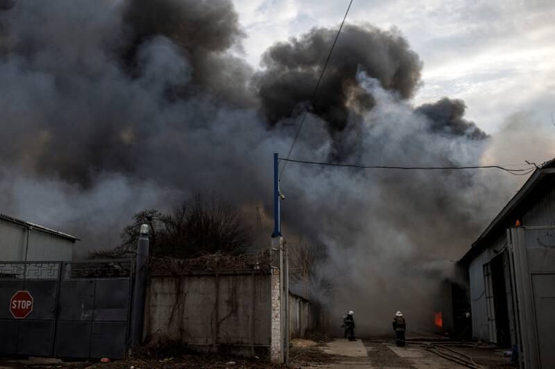 Firefighters try to contain a blaze at a factory after Russian shelling in Kharkiv, Ukraine. Reuters