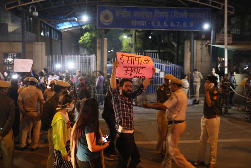 Police hold back crowds gathered outside Delhi's Tihar jail during the executions. AP Photo