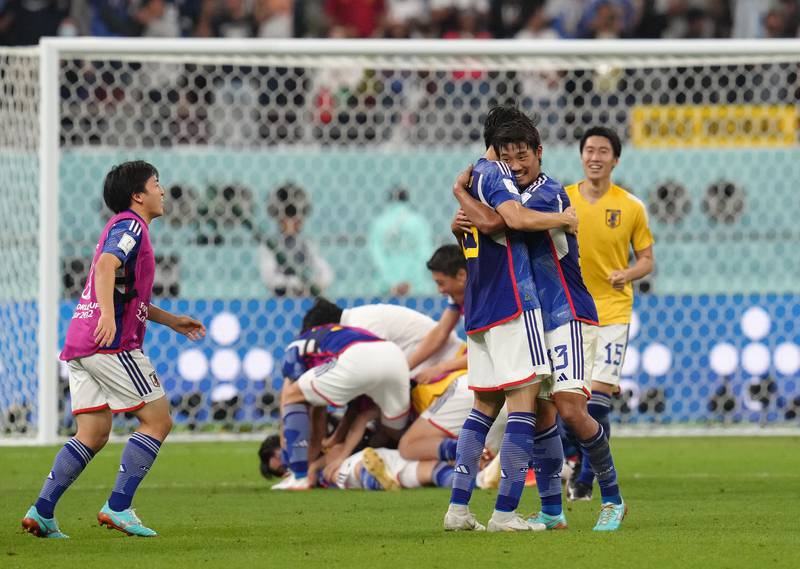Japan's Hidemasa Morita celebrates with teammates at the final whistle. PA