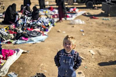 A child looks on at the Kurdish-run al-Hol camp for the displaced in the al-Hasakeh governorate in northeastern Syria on January 14, 2020, where families of Islamic State (IS) foreign fighters are held. - Kurdish authorities in northeast Syria warned that a UN vote to scrap The Yaroubiya entry point for cross-border aid will cripple at least half of the healthcare response in an area ravaged by battles, disrupting 60 to 70 percent of medical assistance to Al-Hol", an overcrowded desert camp brimming with tens of thousands of civilians and IS families, a Kurdish aid official said. (Photo by Delil SOULEIMAN / AFP)