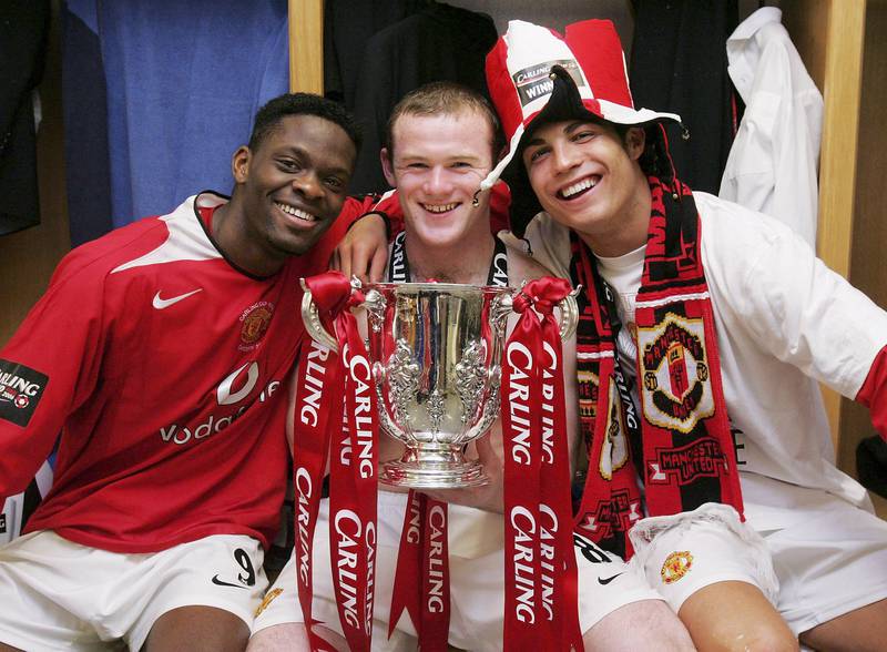 (L-R) Louis Saha, Wayne Rooney and Cristiano Ronaldo pose with the League Cup trophy after defeating Wigan Athletic in 2006. Getty Images
