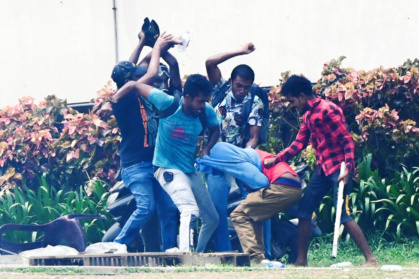 Demonstrators and government supporters clash outside the president's office in Colombo on Monday. AFP