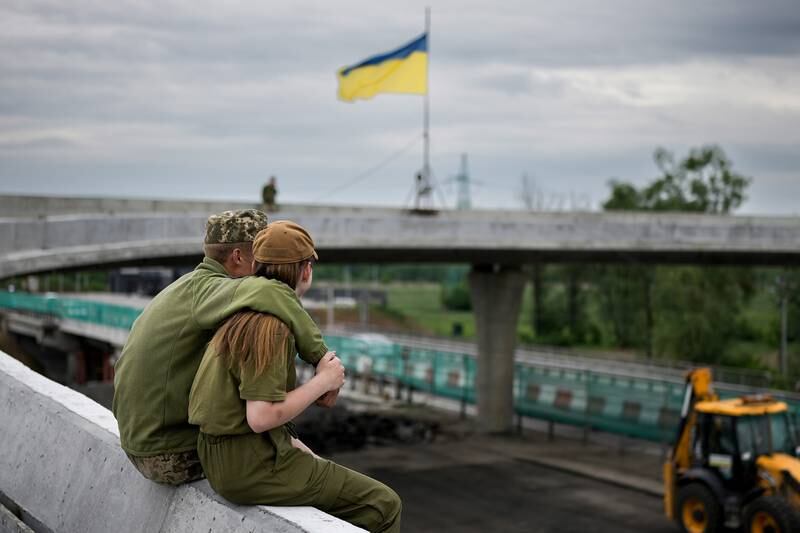 Two Ukrainian soldiers enjoy a tender off-duty moment near the village of Stoyanka, Kyiv region. GettyImages