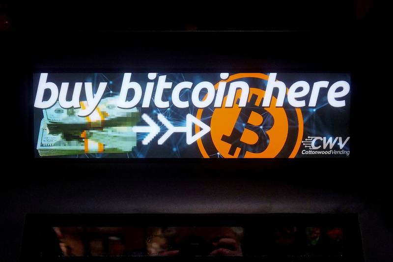 FILE PHOTO: A Bitcoin ATM sign is pictured in a bodega in the Manhattan borough of New York City, New York, U.S., February  9, 2021. REUTERS/Carlo Allegri/File Photo