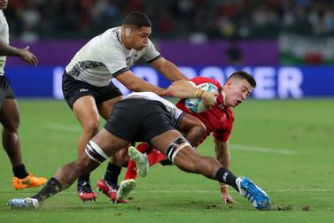 Josh Adams of Wales is tackled during the Rugby World Cup game against Fiji at the Oita Stadium. Getty