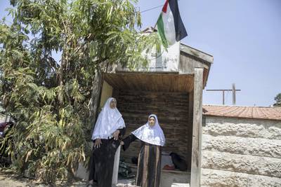  A Palestinian flag is seen above the entrance of the home of the Palestinian Shamasneh family 
as Fahima Shamasneh (right) stands together with her neighbor at the  entrance of her tiny basement home in the East Jerusalem neighborhood of Sheik Jarrah on August 11,2017.A Palestinian flag is seen above the entrance of the home of the Palestinian Shamasneh family 

When the Shamasne family first moved into their home  in the 1960s, East Jerusalem was controlled by Jordan and their monthly rent was paid to  Jordanian authorities but since  Israel annexed East Jerusalem in 1967, the Shamasne family has paid their rent to Israel's general custodian in order to remain in the building.
The family claims that their payments were suddenly rejected in 2009 , and they were informed that the property had been claimed by Israeli Jews whose ancestors had lived there decades previously.Although the family has spent years fighting to remain in the home , the Israeli high court has ruled that the family must evacuate the home before August 9. (Photo by Heidi Levine for The National).